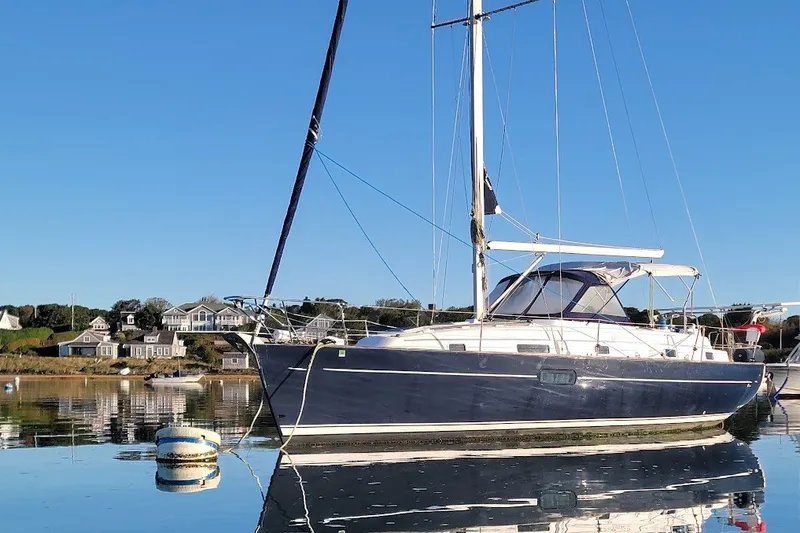 Slide: The Image of 2001 Beneteau Oceanis Clipper 36 CC sailboat anchored in calm waters. - 13