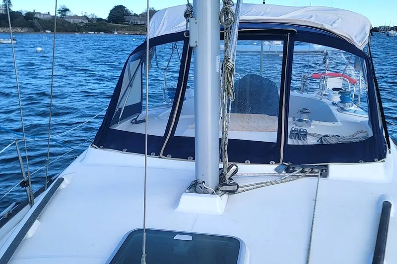 Slide: The Image of 2001 Beneteau Oceanis Clipper 36 CC sailboat on calm water, featuring a covered cockpit. - 6