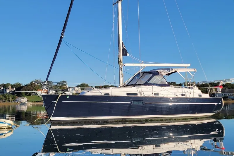The Image of 2001 Beneteau Oceanis Clipper 36 CC sailboat on calm water, clear blue sky. - 0