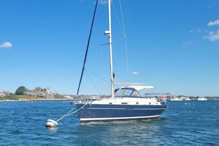 Slide: The Image of 2001 Beneteau Oceanis Clipper 36 CC sailboat anchored in calm blue waters. - 12