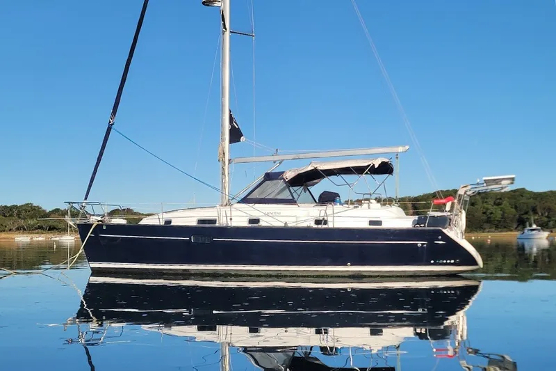 Slide: The Image of 2001 Beneteau Oceanis Clipper 36 CC sailboat on calm water, clear blue sky background. - 9