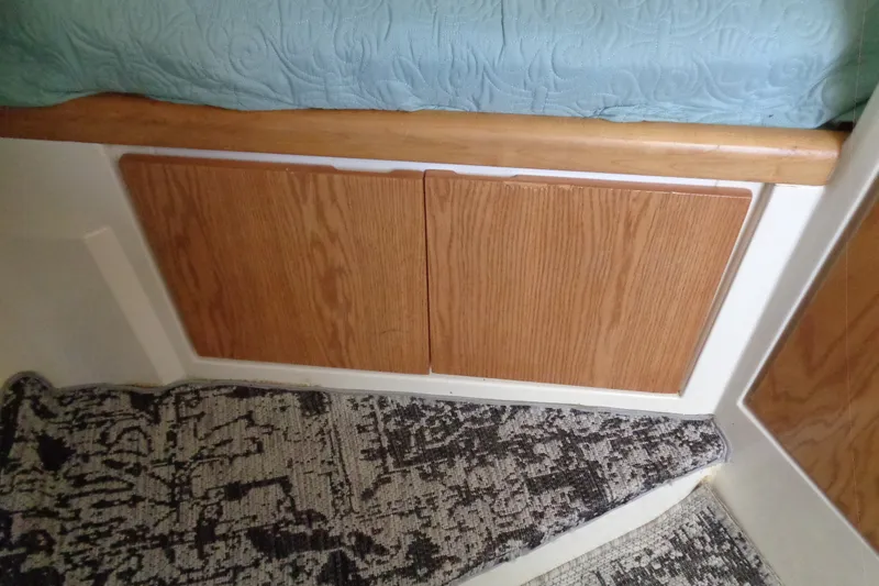 Slide: The Image of Interior of 1994 Bertram 30 Moppie with wooden cabinetry and patterned carpet. - 27