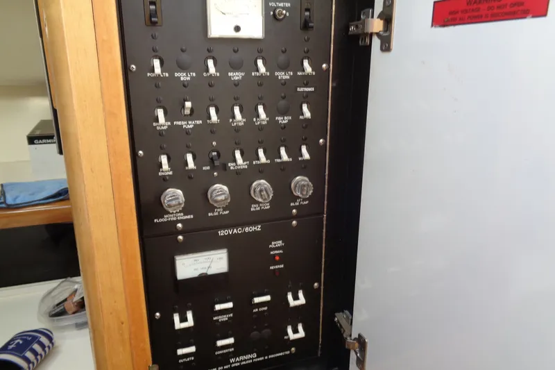 Slide: The Image of Electrical control panel inside a 1994 Bertram 30 Moppie boat, featuring various switches and gauges. - 42