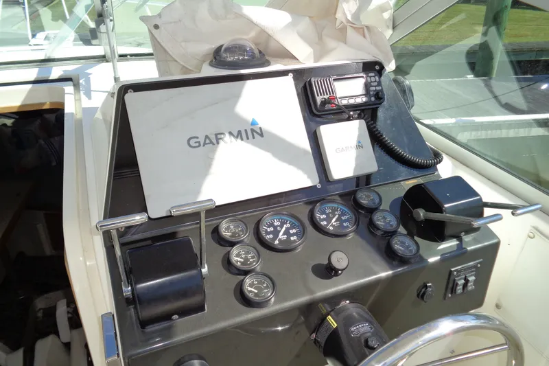 Slide: The Image of Control panel of a 1994 Bertram 30 Moppie boat with Garmin navigation equipment. - 14