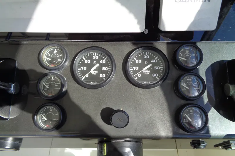 Slide: The Image of Dashboard of a 1994 Bertram 30 Moppie boat with various gauges and controls. - 15