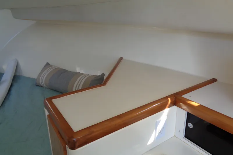 Slide: The Image of Interior of 1994 Bertram 30 Moppie boat with cushion and wooden trim. - 41