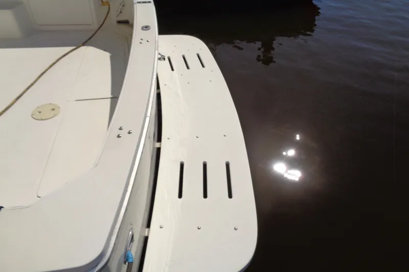 Slide: The Image of Swim platform of a 1994 Bertram 30 Moppie boat reflecting sunlight on water. - 8