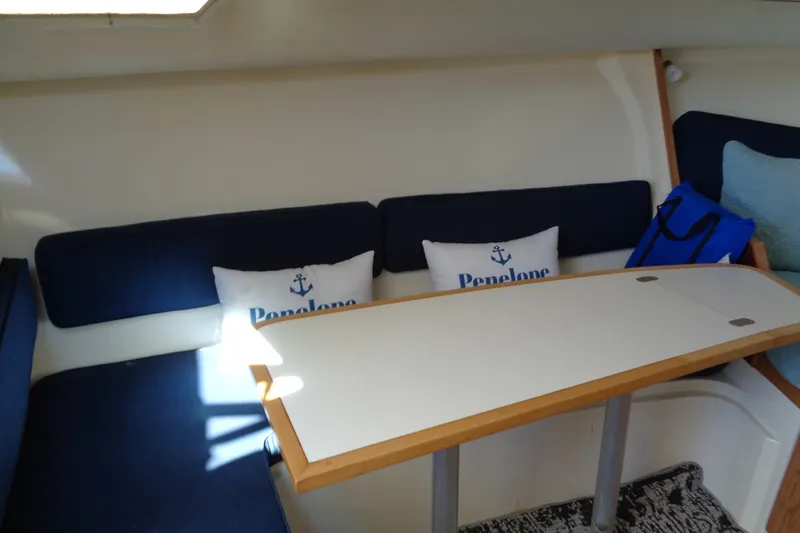 Slide: The Image of Interior of 1994 Bertram 30 Moppie boat with blue seating and white table. - 31