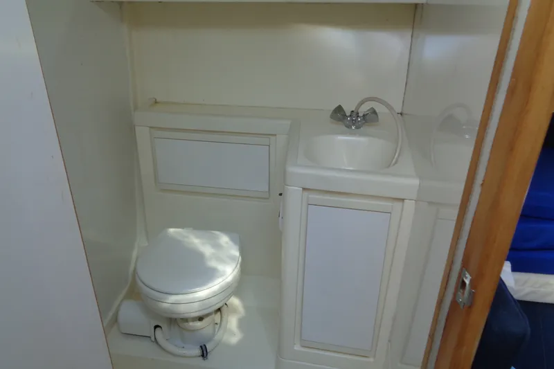 Slide: The Image of Bathroom interior of 1994 Bertram 30 Moppie boat with toilet and sink. - 38