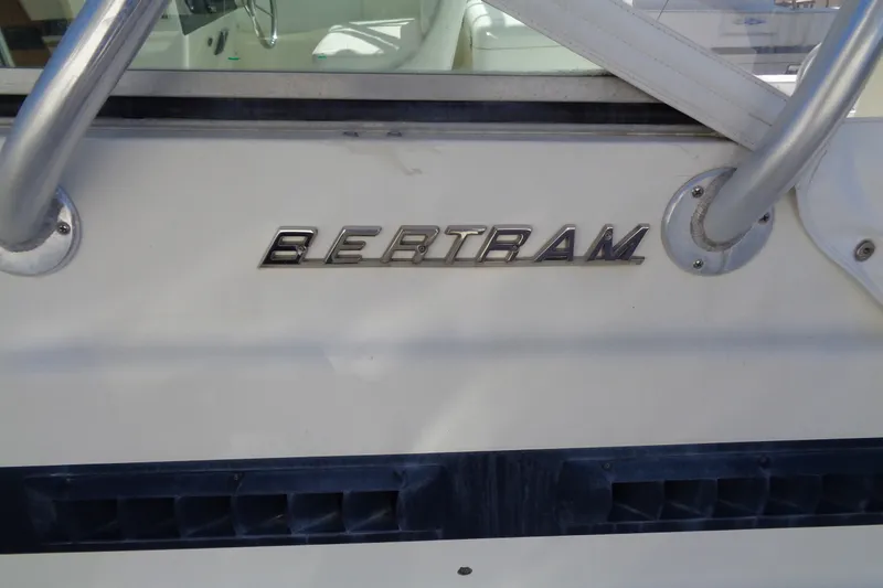 Slide: The Image of 1994 Bertram 30 Moppie boat with chrome logo and railing detail. - 5