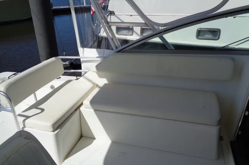 Slide: The Image of 1994 Bertram 30 Moppie boat interior with white seating and sleek design. - 20