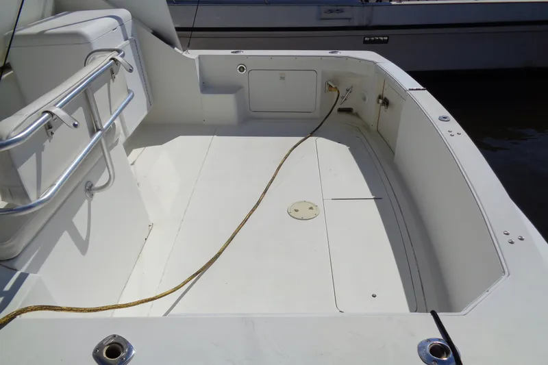 Slide: The Image of 1994 Bertram 30 Moppie boat deck with clean, spacious layout and railing. - 7