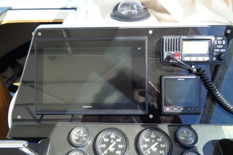 Slide: The Image of Control panel of a 1994 Bertram 30 Moppie boat with Garmin navigation equipment. - 16