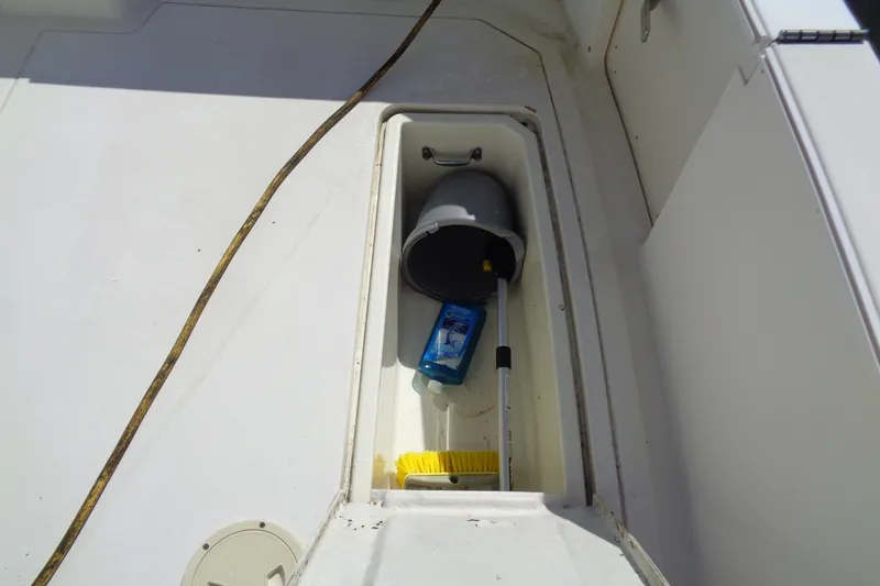 Slide: The Image of Storage compartment on 1994 Bertram 30 Moppie boat with cleaning supplies and bucket. - 9