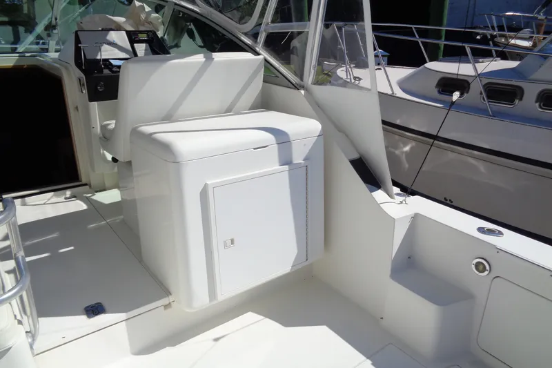Slide: The Image of 1994 Bertram 30 Moppie boat interior with white seating and control panel. - 12