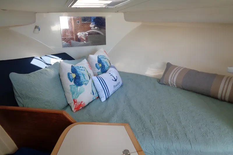 Slide: The Image of Cozy cabin interior of 1994 Bertram 30 Moppie with decorative pillows and bedding. - 26