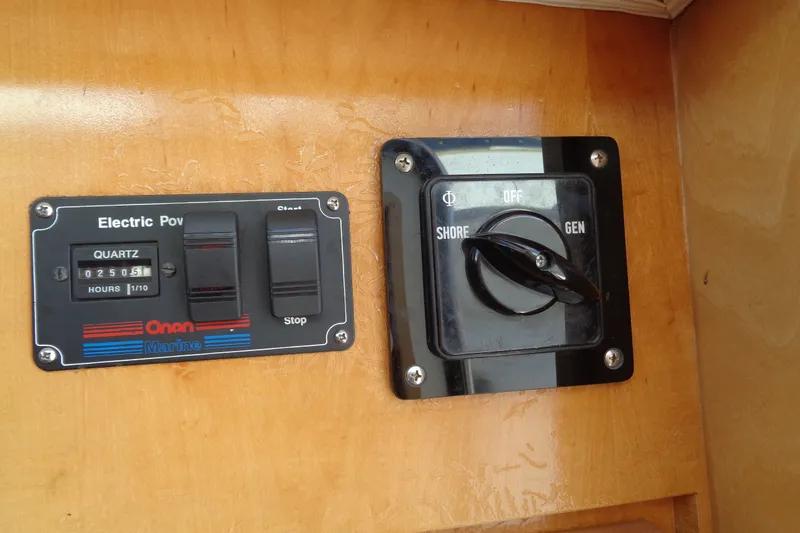 Slide: The Image of Electric power panel on 1994 Bertram 30 Moppie boat, featuring Onan Marine controls. - 44