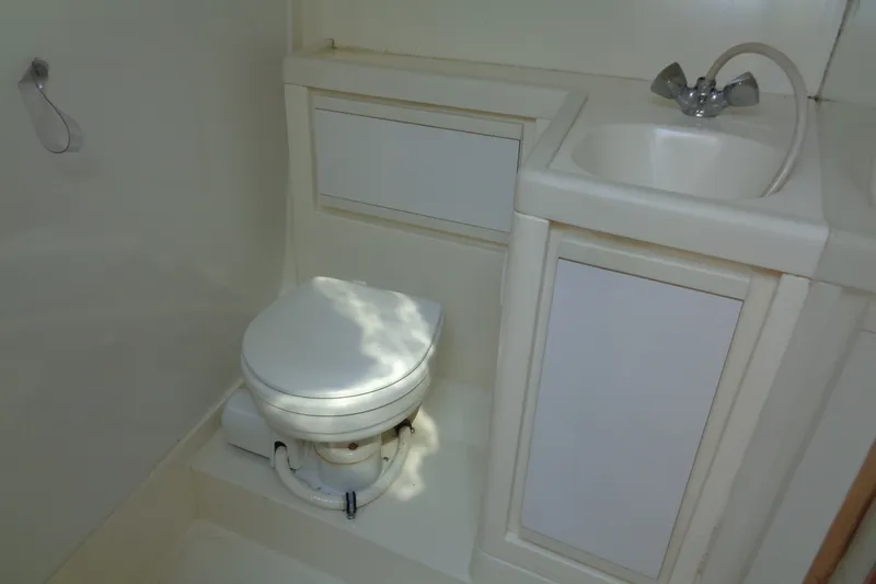Slide: The Image of Compact bathroom in a 1994 Bertram 30 Moppie boat with toilet and sink. - 40
