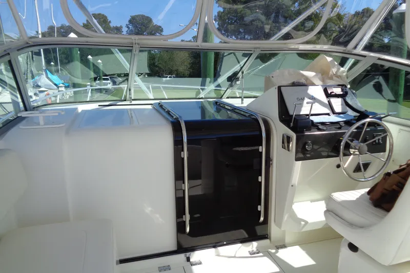 Slide: The Image of 1994 Bertram 30 Moppie boat interior with steering wheel and navigation equipment. - 22