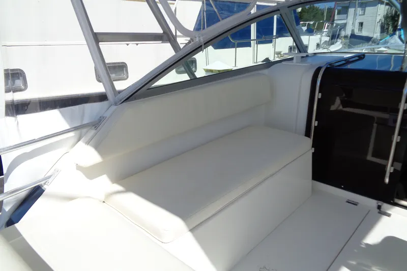 Slide: The Image of 1994 Bertram 30 Moppie boat interior with white seating and sleek design. - 21