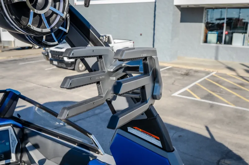 Slide: The Image of 2018 Tigé RZX3 boat with wakeboard rack and speaker in a parking lot. - 22