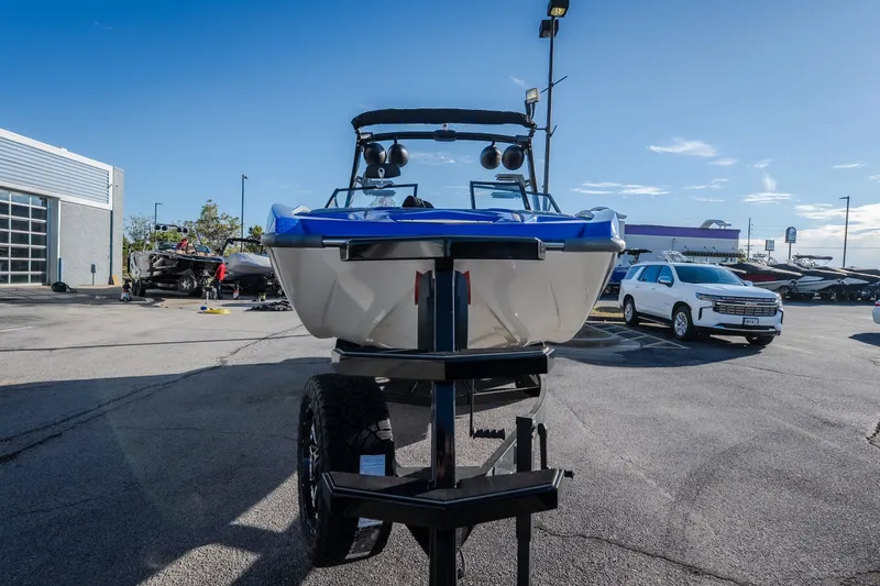 Slide: The Image of 2018 Tigé RZX3 boat on trailer in parking lot, sunny day. - 31