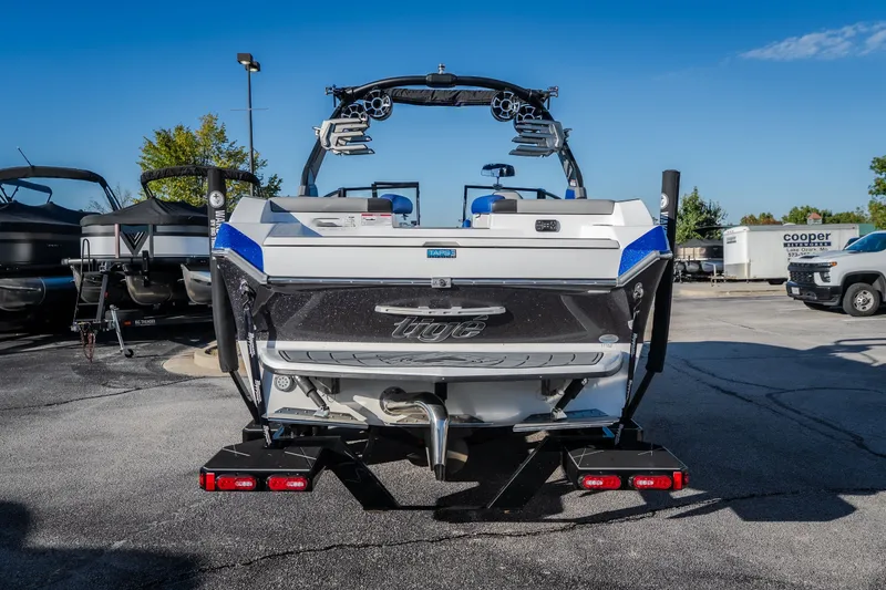 Slide: The Image of 2018 Tigé RZX3 boat rear view in a parking lot, showcasing sleek design and features. - 32