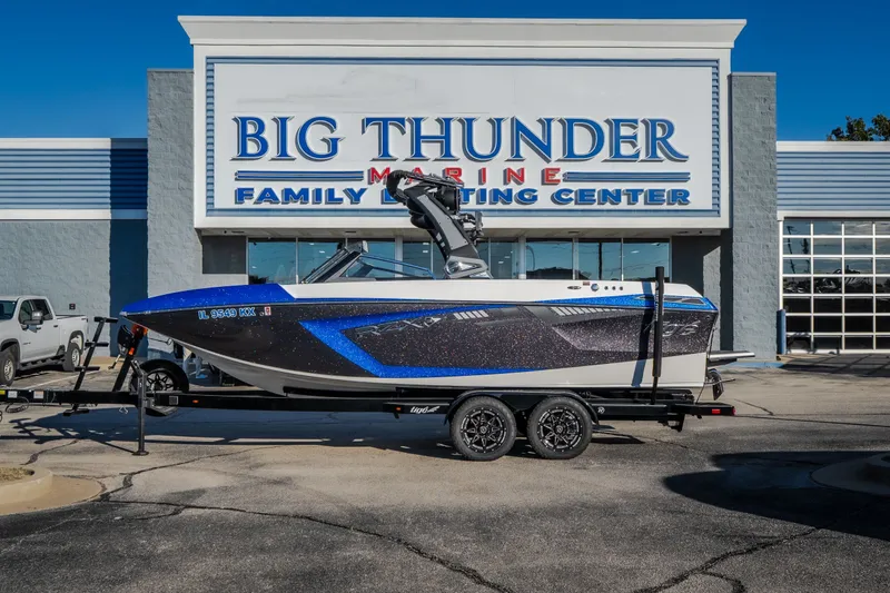 Slide: The Image of 2018 Tigé RZX3 boat on trailer at Big Thunder Marine center. - 1