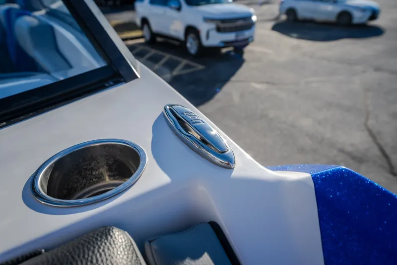 Slide: The Image of 2018 Tigé RZX3 boat interior detail with cup holder and logo emblem. - 17
