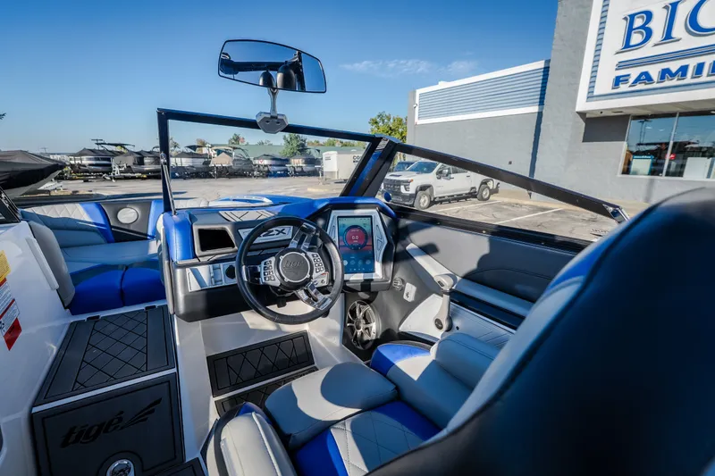 Slide: The Image of Interior of a 2018 Tigé RZX3 boat with modern dashboard and steering wheel. - 49