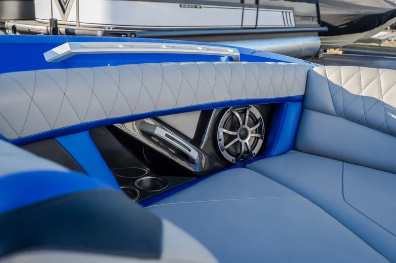 Slide: The Image of 2018 Tigé RZX3 boat interior with blue and gray upholstery and speaker system. - 13