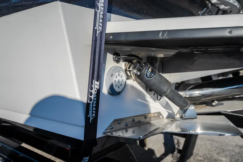 Slide: The Image of 2018 Tigé RZX3 boat detail showing hydraulic system and Boatmate trailer strap. - 38