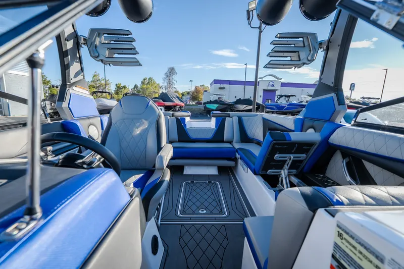 Slide: The Image of 2018 Tigé RZX3 boat interior with blue and gray seating, advanced audio system, and sleek design. - 15