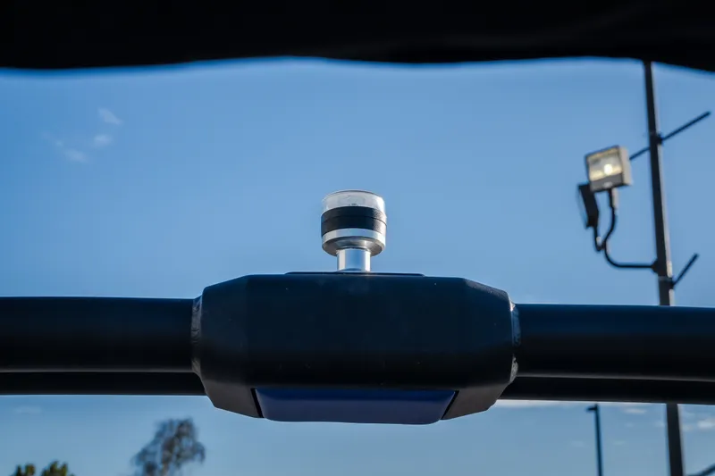 Slide: The Image of Close-up of a 2018 Tigé RZX3 boat component against a clear blue sky. - 40