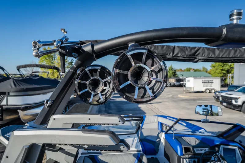 Slide: The Image of 2018 Tigé RZX3 boat with mounted speakers and sleek interior design. - 24
