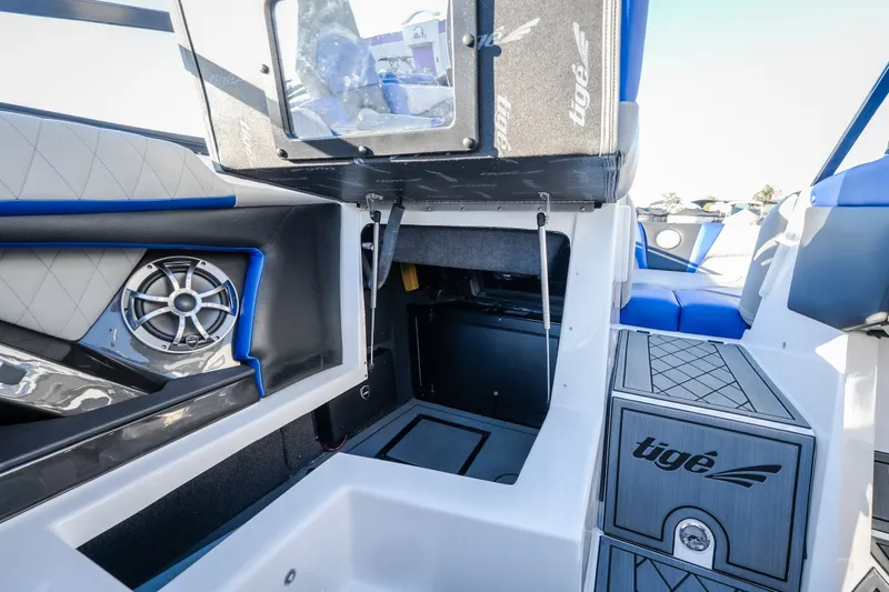 Slide: The Image of 2018 Tigé RZX3 boat interior with speaker, storage, and seating. - 28