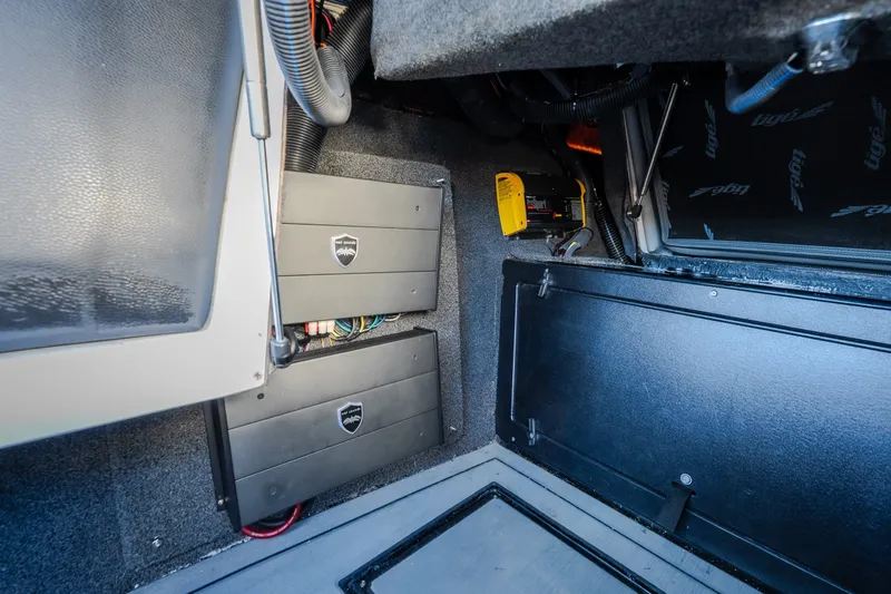 Slide: The Image of Interior view of 2018 Tigé RZX3 boat showing audio system components and wiring. - 27