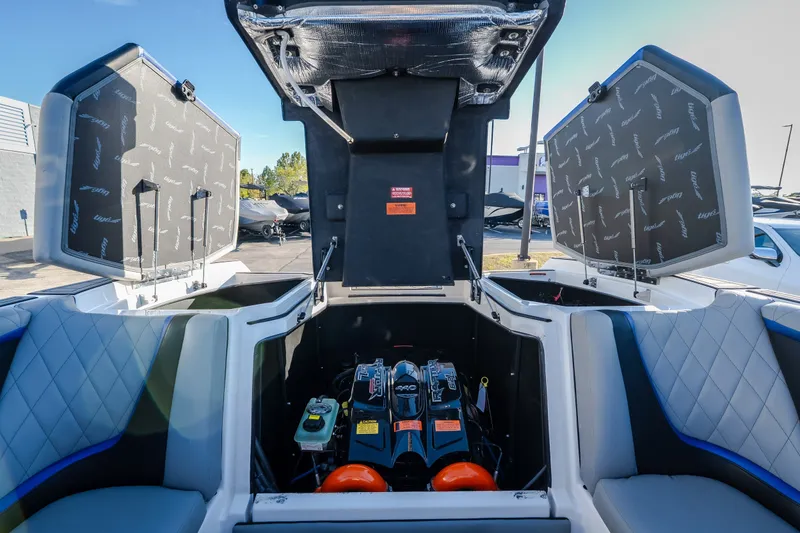 Slide: The Image of 2018 Tigé RZX3 boat engine compartment with open hatches and seating. - 44