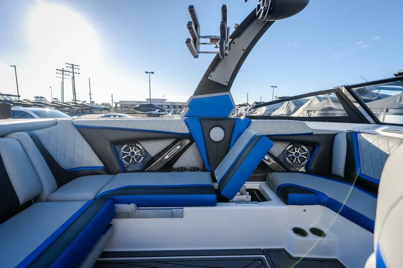 Slide: The Image of Interior of 2018 Tigé RZX3 boat with blue and gray seating, speakers, and sleek design. - 19