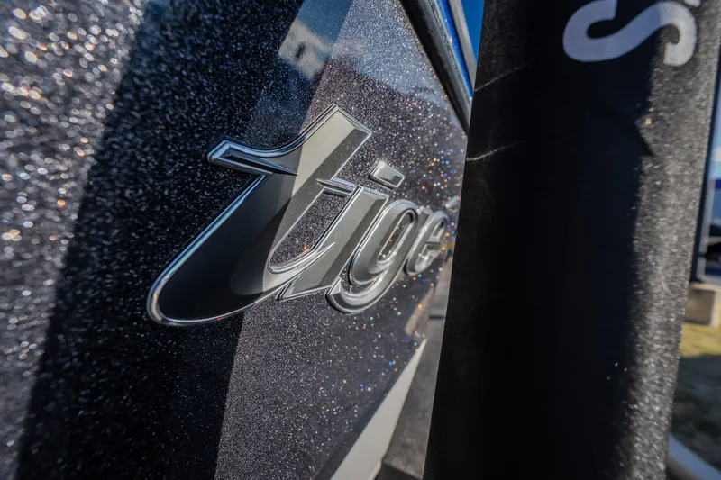 Slide: The Image of Close-up of 2018 Tigé RZX3 logo on a sparkling boat surface. - 37