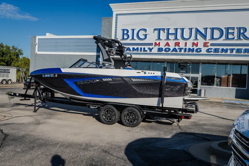 Slide: The Image of 2018 Tigé RZX3 boat on trailer at Big Thunder Marine dealership. - 56