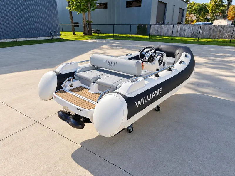 Slide: The Image of 2026 Williams Jet Tenders Sportjet 345 on a trailer, featuring gray and white upholstery. - 7