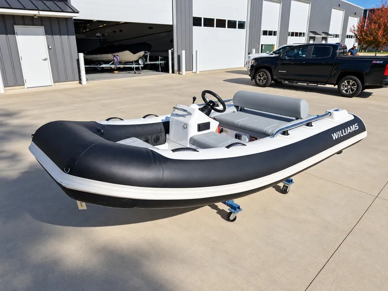 Slide: The Image of 2026 Williams Jet Tenders Sportjet 345 on a trailer in front of a garage. - 3