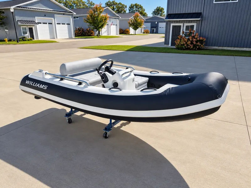 Slide: The Image of 2026 Williams Jet Tenders Sportjet 345 on a trailer in a modern courtyard. - 1
