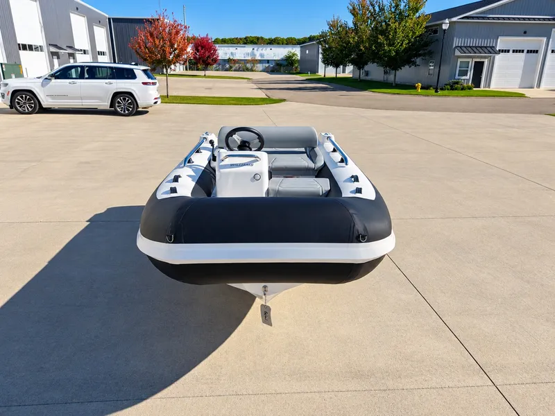 Slide: The Image of 2026 Williams Jet Tenders Sportjet 345 on a parking lot, surrounded by buildings and trees. - 2