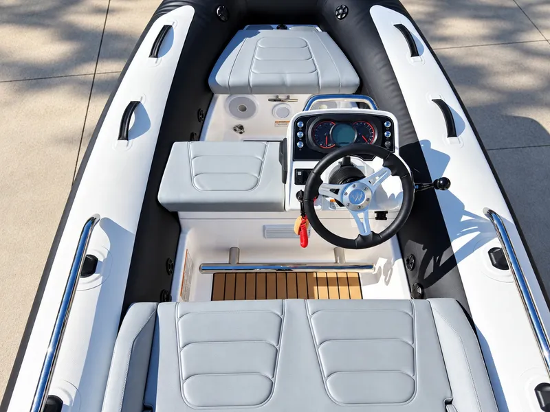 Slide: The Image of The image shows the cockpit of a 2026 Williams Jet Tenders Sportjet 345 with gray seating and a modern helm. - 9