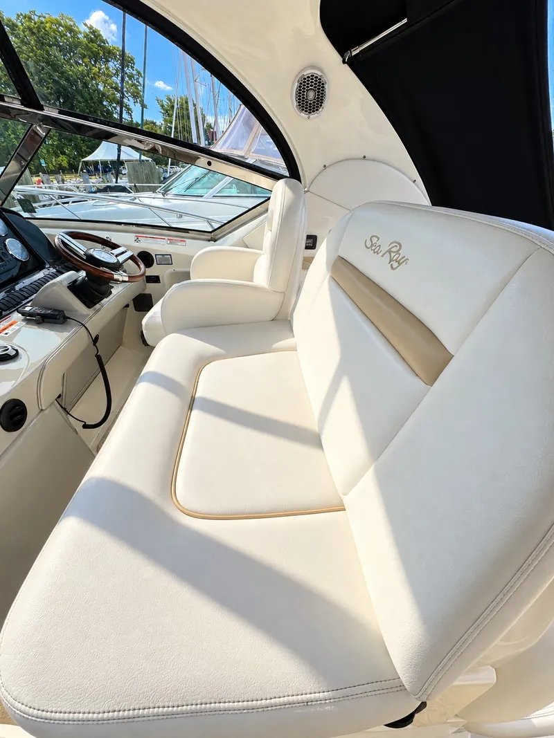 Slide: The Image of Interior of the 2010 Sea Ray 390 Sundancer with beige seating and steering wheel. - 12