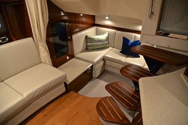 Slide: The Image of Interior of the 2010 Sea Ray 390 Sundancer with elegant seating and wood accents. - 31