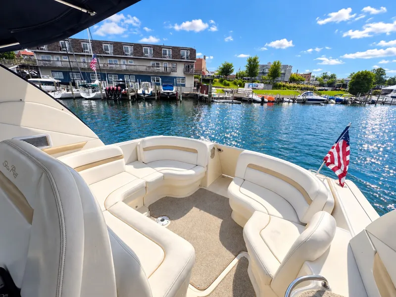 Slide: The Image of The image shows the stern of a 2010 Sea Ray 390 Sundancer with comfortable seating and an American flag. - 8