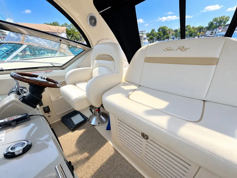 Slide: The Image of The cockpit of a 2010 Sea Ray 390 Sundancer with comfortable seating and sleek design. - 13